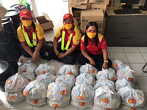 Baliuag staff excitedly prepare relief packs purchased using collected tips to purchase their donation