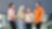 A group of employees are standing and having a casual chat and laughing