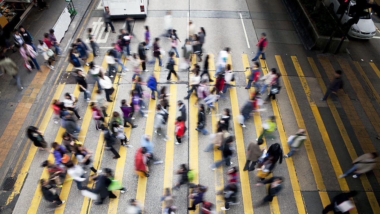 People crossing a busy street in Hong Kong