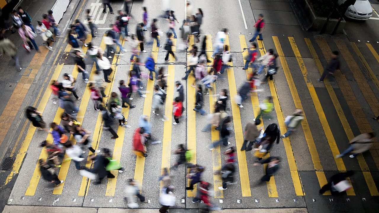People crossing a busy street in Hong Kong