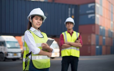 Two co workers smiling and talking
