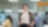 person stands confidently in a modern office environment with hands in pockets