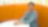 A woman seated at a table in an orange office setting