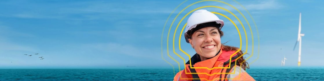 A woman wearing personal protective equipment standing in front of an ocean