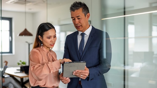 Two people studying a file