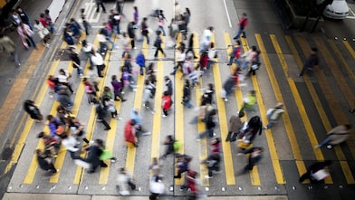 People crossing a busy street in Hong Kong