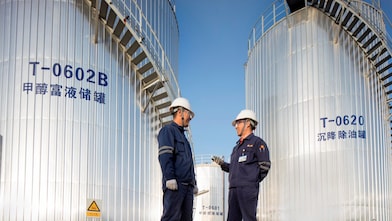 Two Asian Shell engineers meeting at an operational site.