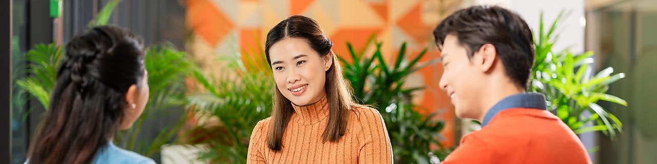 Team collaboration around laptop in modern office setting