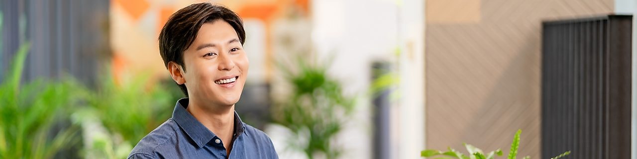 Person seated at a wooden table using a laptop