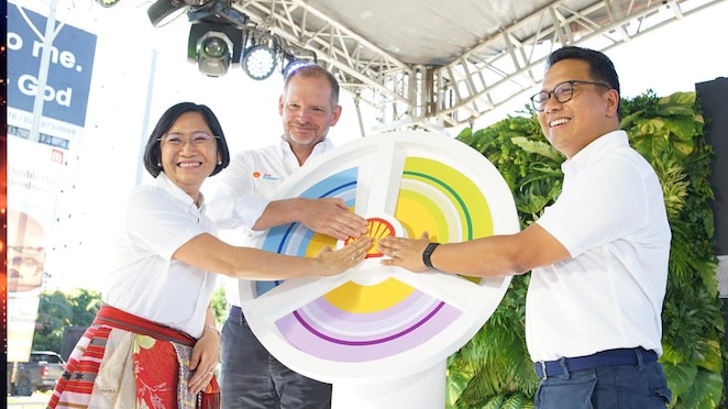 Three people holding Shell Logo