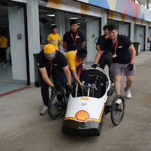 Beyond Borders cooperation is on display as students from Kazakhstan and the Philippines work together to push Avalon, UPHSD's vehicle, to technical inspection.
