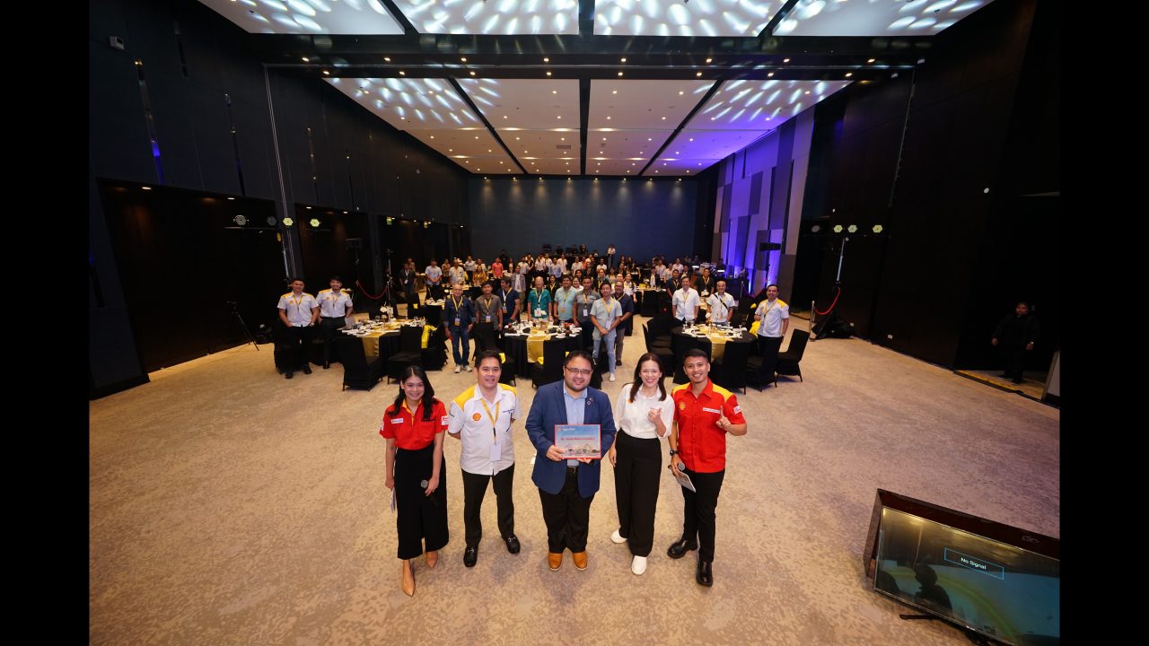 Jonas Marie Dumdum of Nomura Research Institute receives a token of gratitude from Chris Alli, Head of Shell Fleet and CRT, and Jackie Famorca, Shell Pilipinas Vice President for Lubricants.
