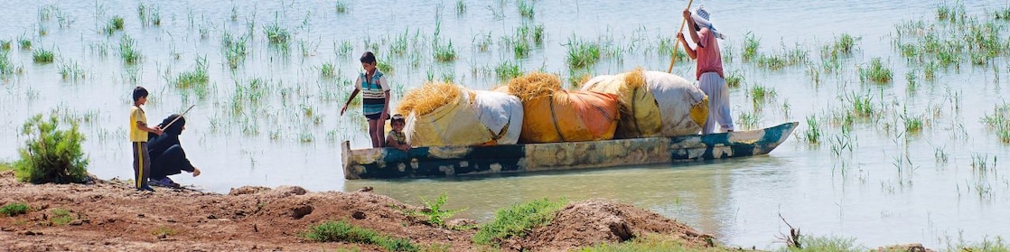 Local people cross the flooded Hawizeh Marshes, near the Majnoon project in Iraq