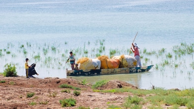Local people cross the flooded Hawizeh Marshes, near the Majnoon project in Iraq