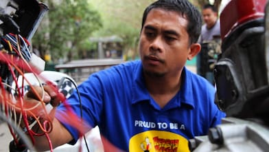 A USP scholar meticulously doing some repair work