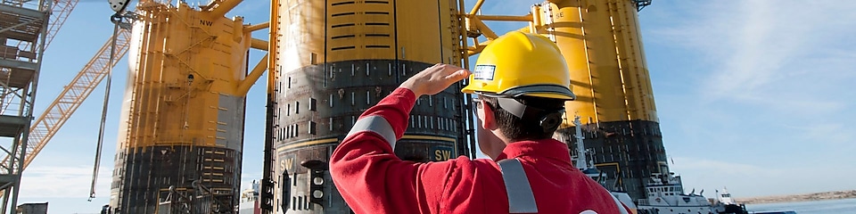 Engineer looking up at platform under construction