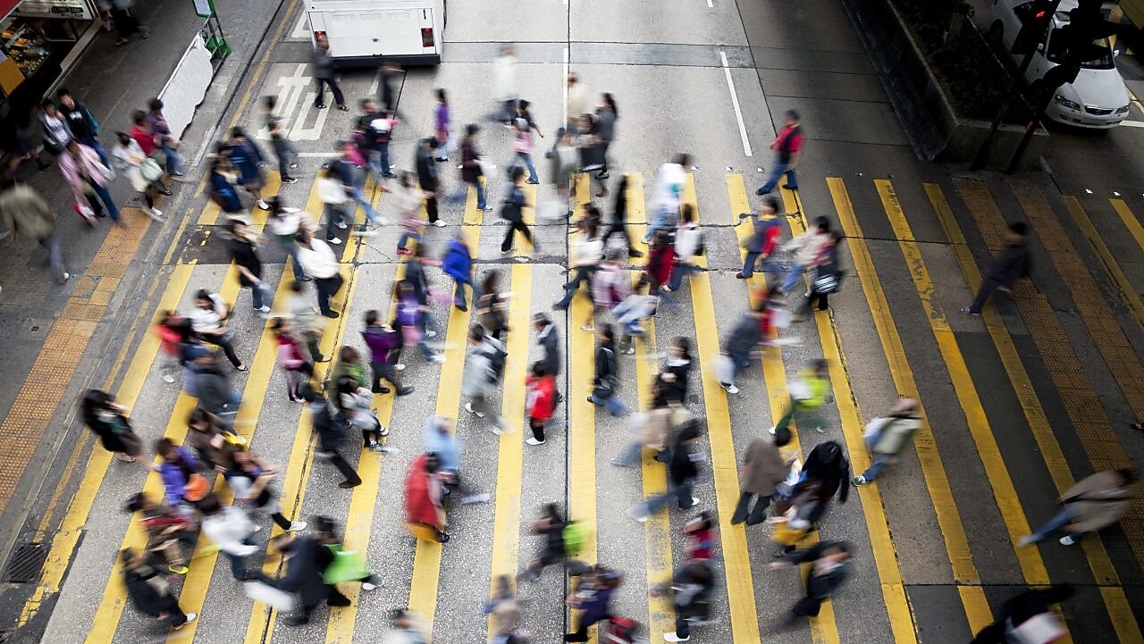 People crossing a busy street in Hong Kong