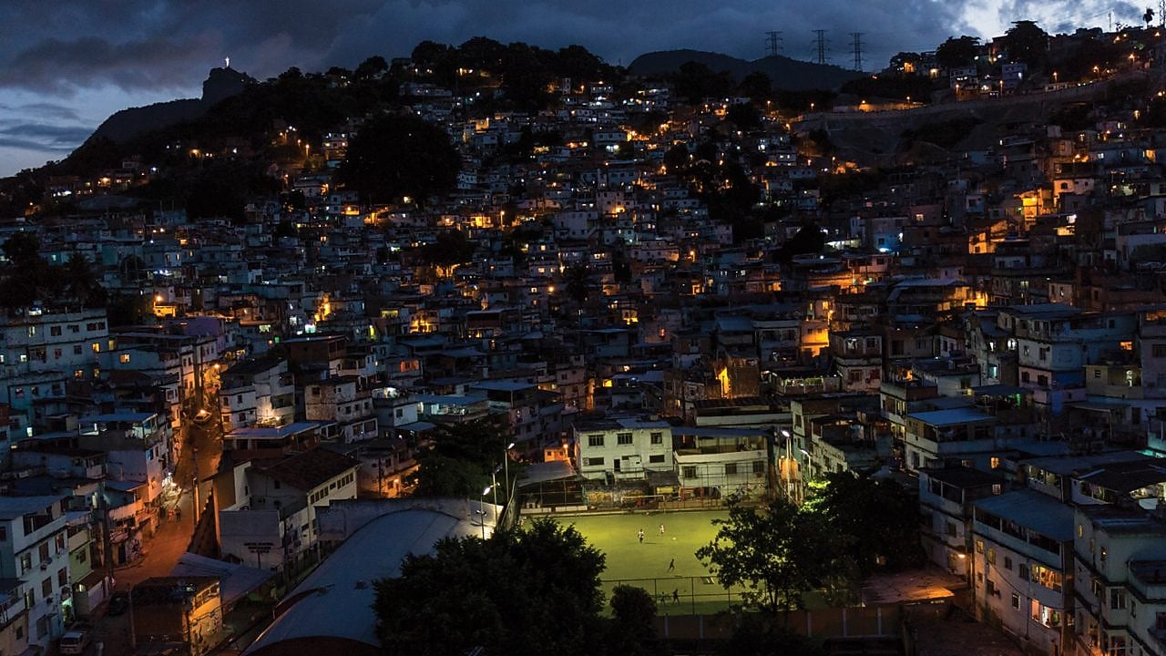 Football pitch lit up in the middle of the city at night