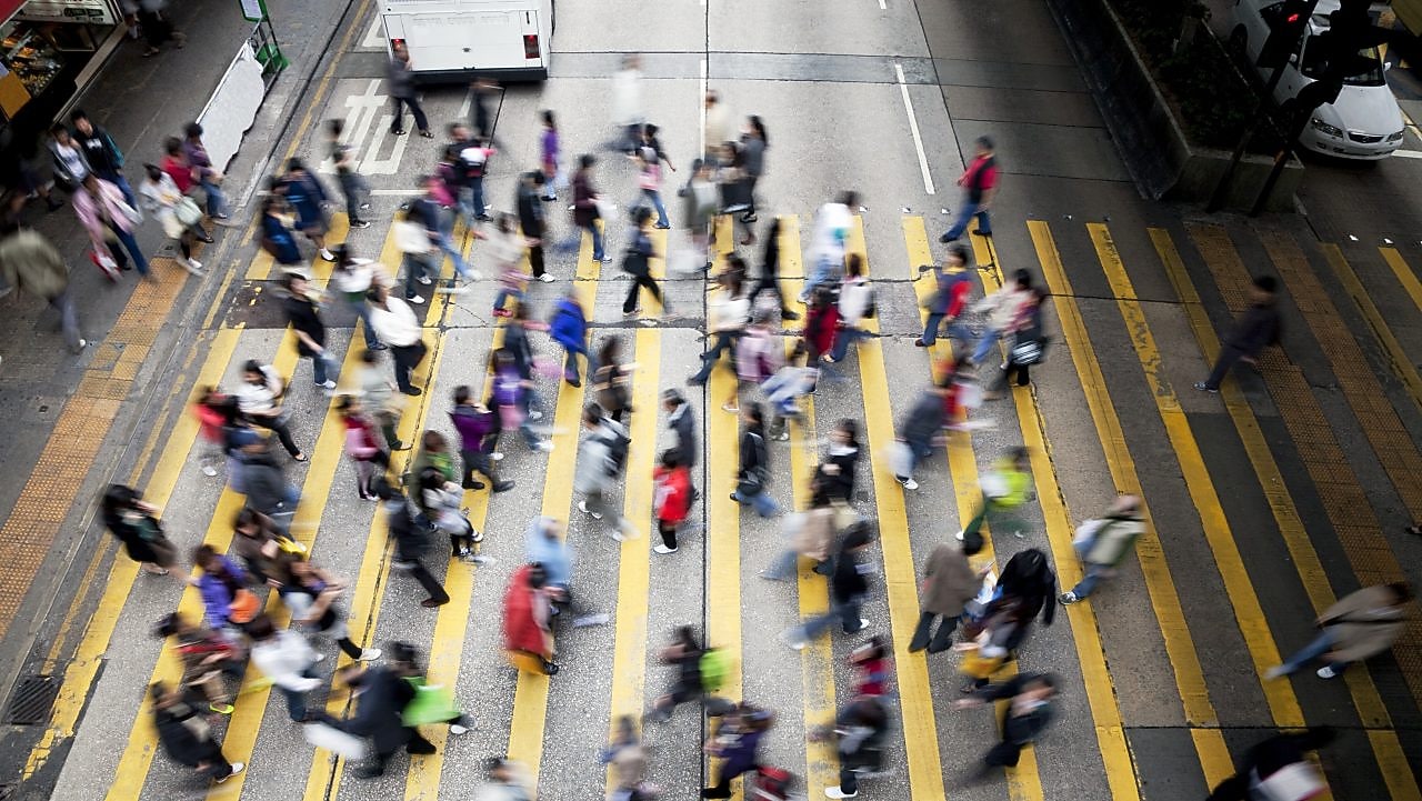 People crossing a busy street in Hong Kong