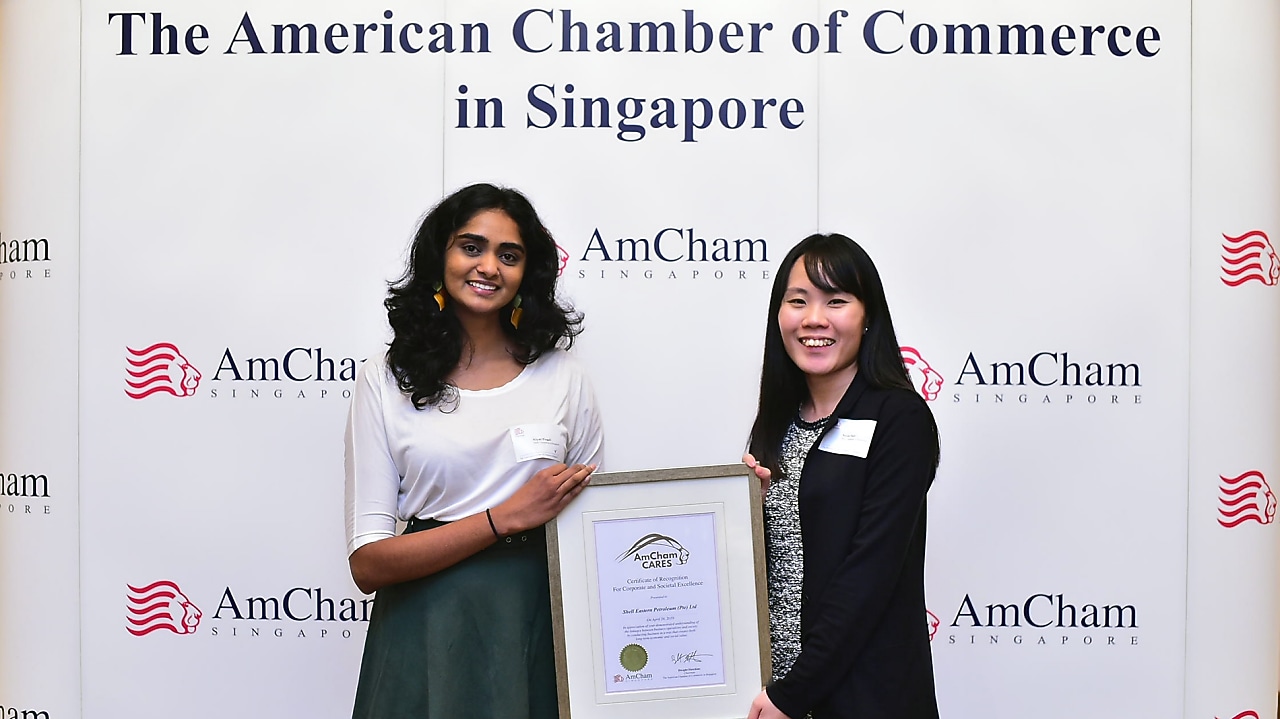 (From left to right) External Relations Advisors Niyati Pingali (left) and Nicole Pauh (right) receive the AmCham Cares for Corporate and Societal Excellence award on Shell’s behalf