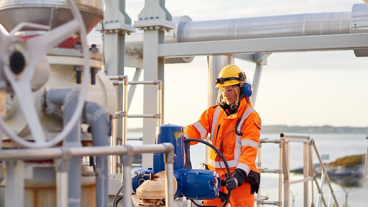 Female frontline worker looking at equipment.