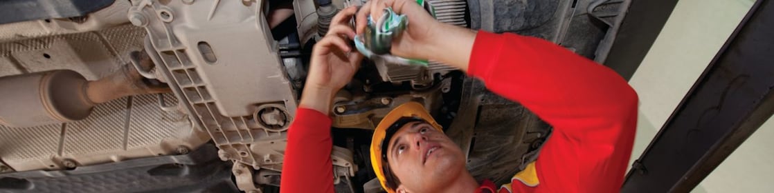 employee doing fitting of parts in car