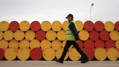 man walking barrels lubricants