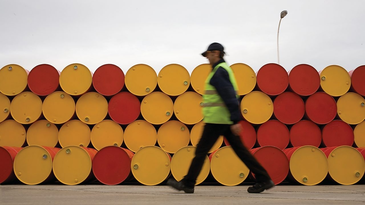 man walking barrels lubricants