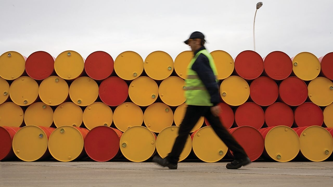 man walking barrels lubricants