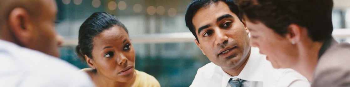 Four smart individuals in the middle of a meeting