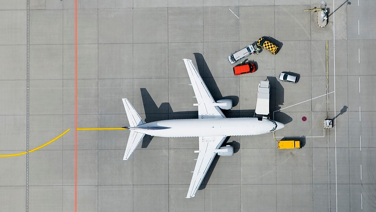 Aerial view of airplane and vans