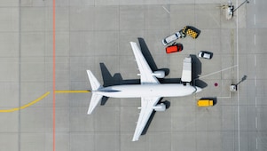 Aerial view of airplane and vans