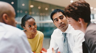 Four smart individuals in the middle of a meeting