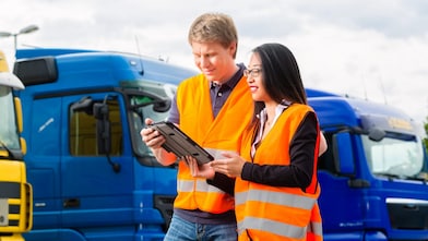 Fleet managers in front of trucks