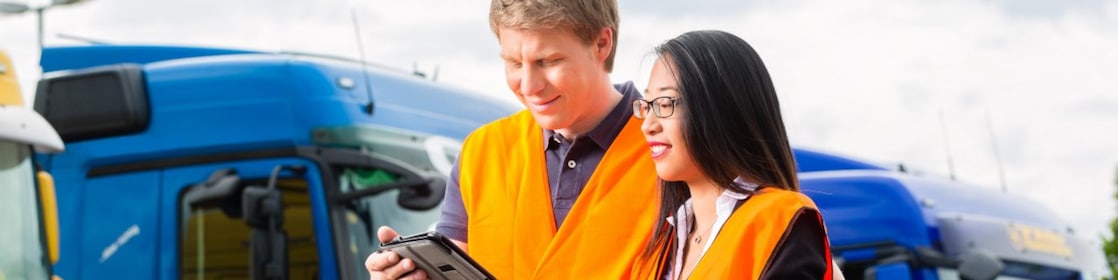 Fleet managers in front of trucks