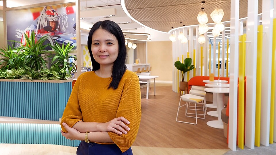 A woman standing in a warm and vibrant office ambiance