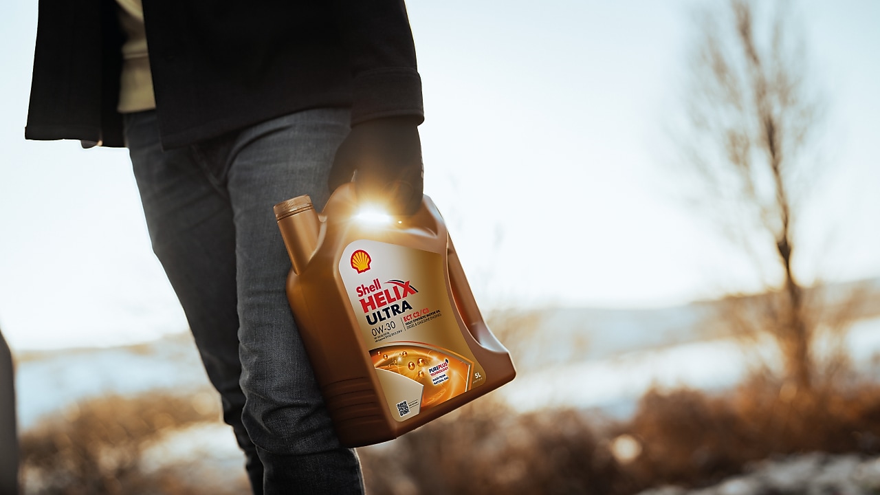 Man holding Shell Helix Ultra bottle