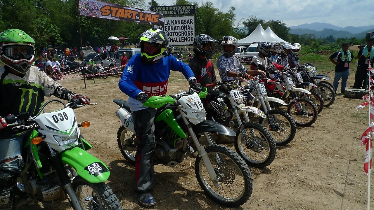 Motorcross motorcycles lining up at the start of a race