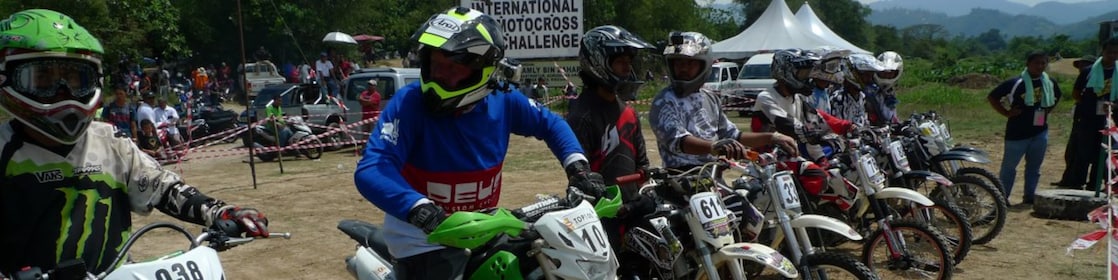 Motorcross motorcycles lining up at the start of a race