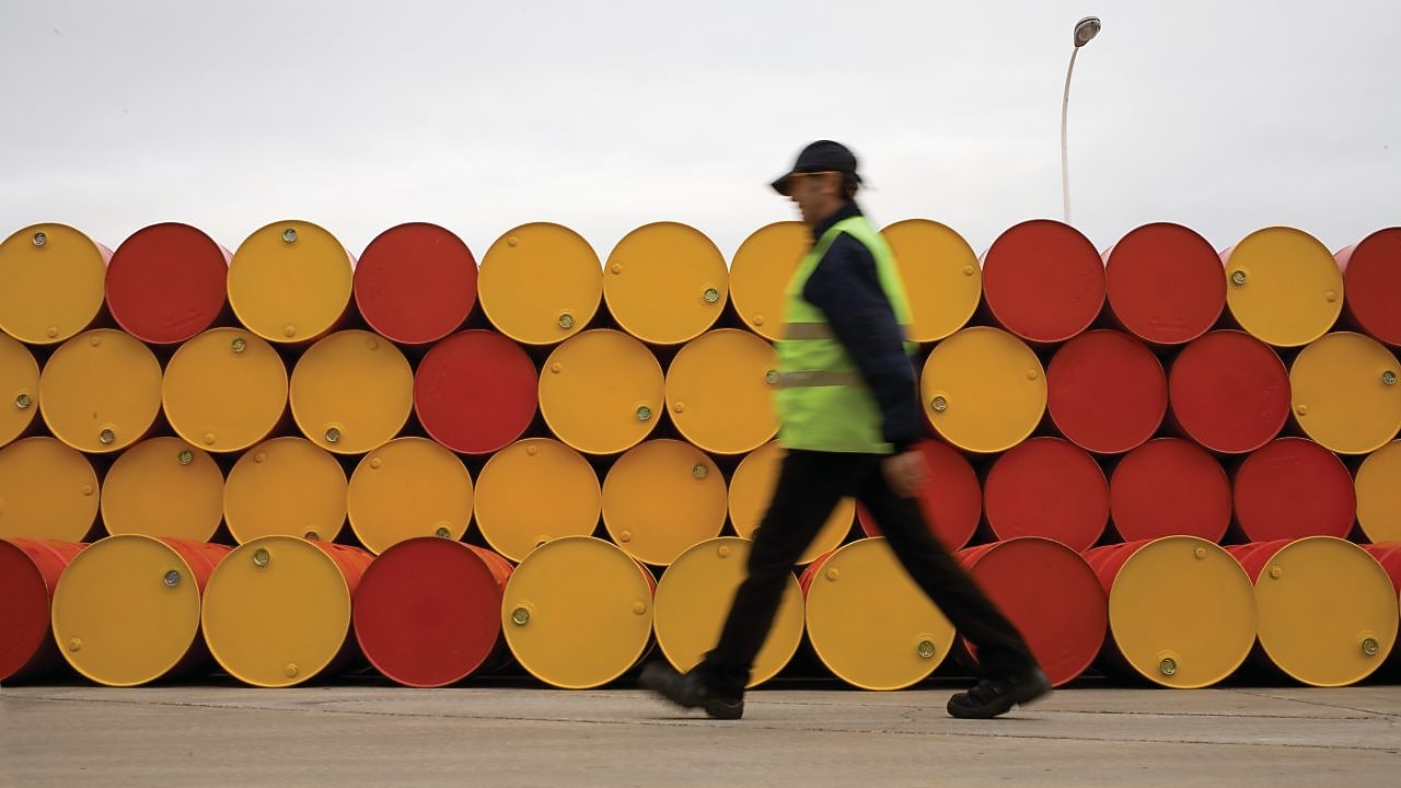 man walking barrels lubricants