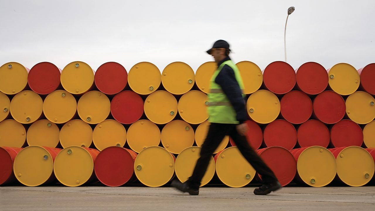 Man walking past barrels of Lubricants