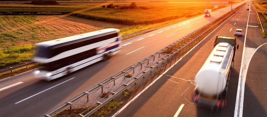 Bus and truck at the sunset