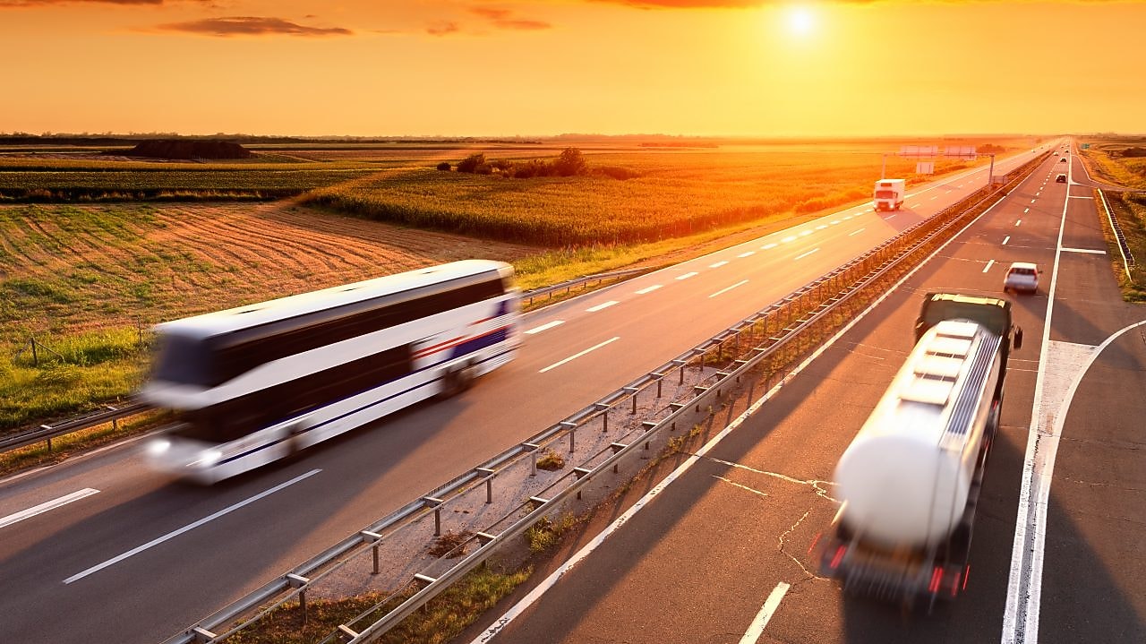 Bus and truck at the sunset