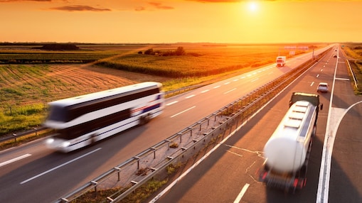 Bus and truck at the sunset
