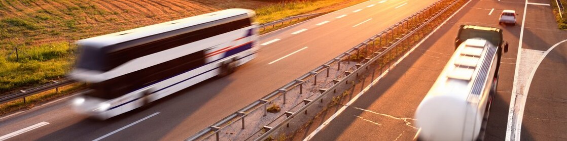 Bus and truck at the sunset