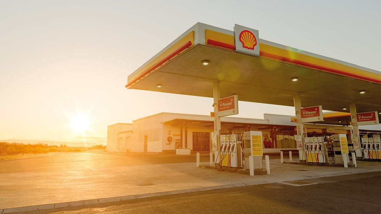 The forecourt of a shell service station at dusk