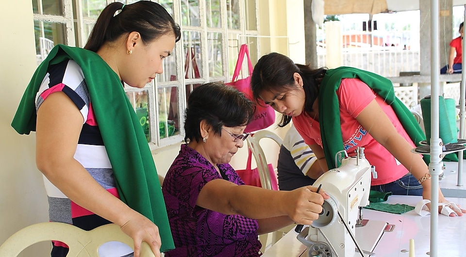 Two ladies looking at sewing instructor