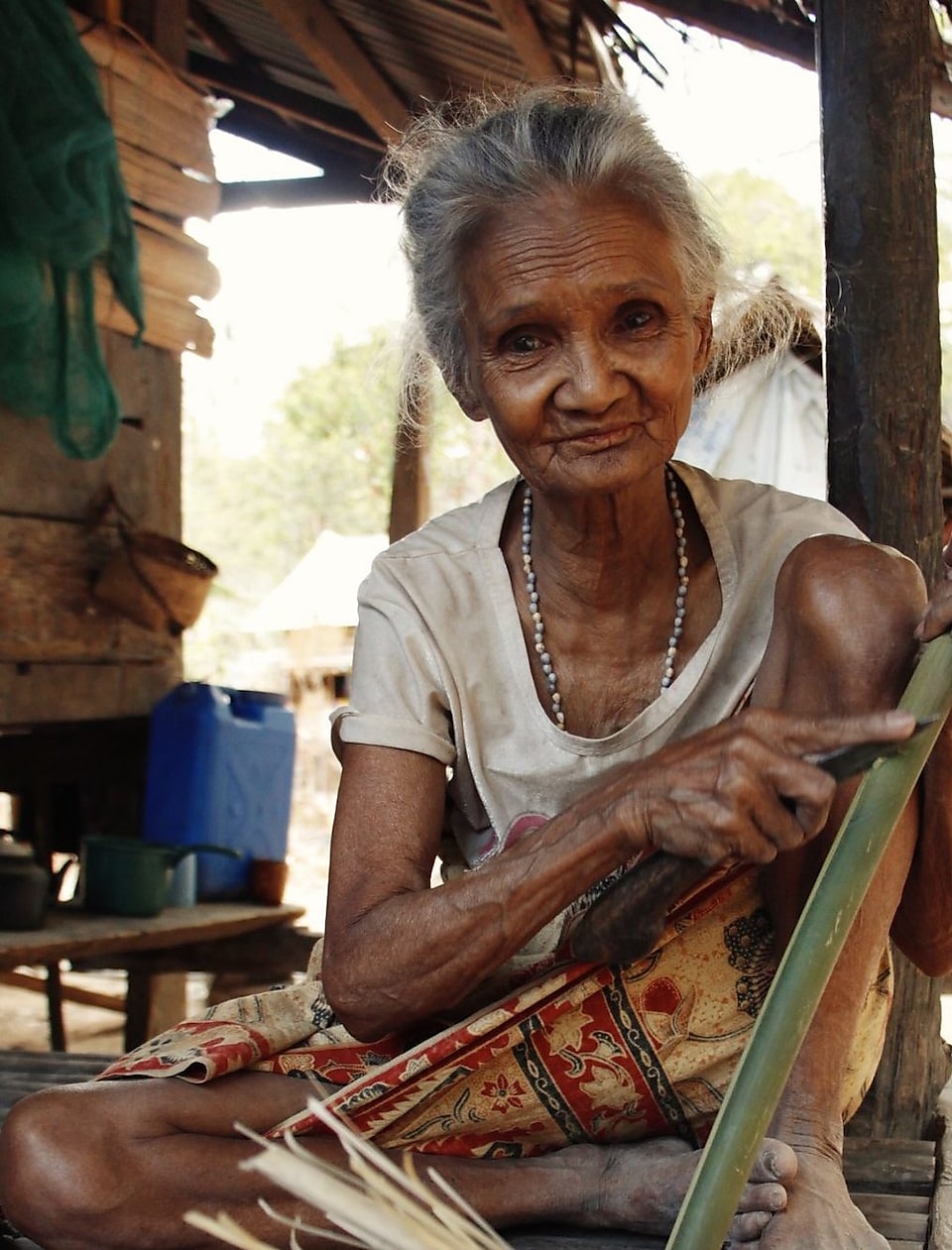 A Batak woman making a basket